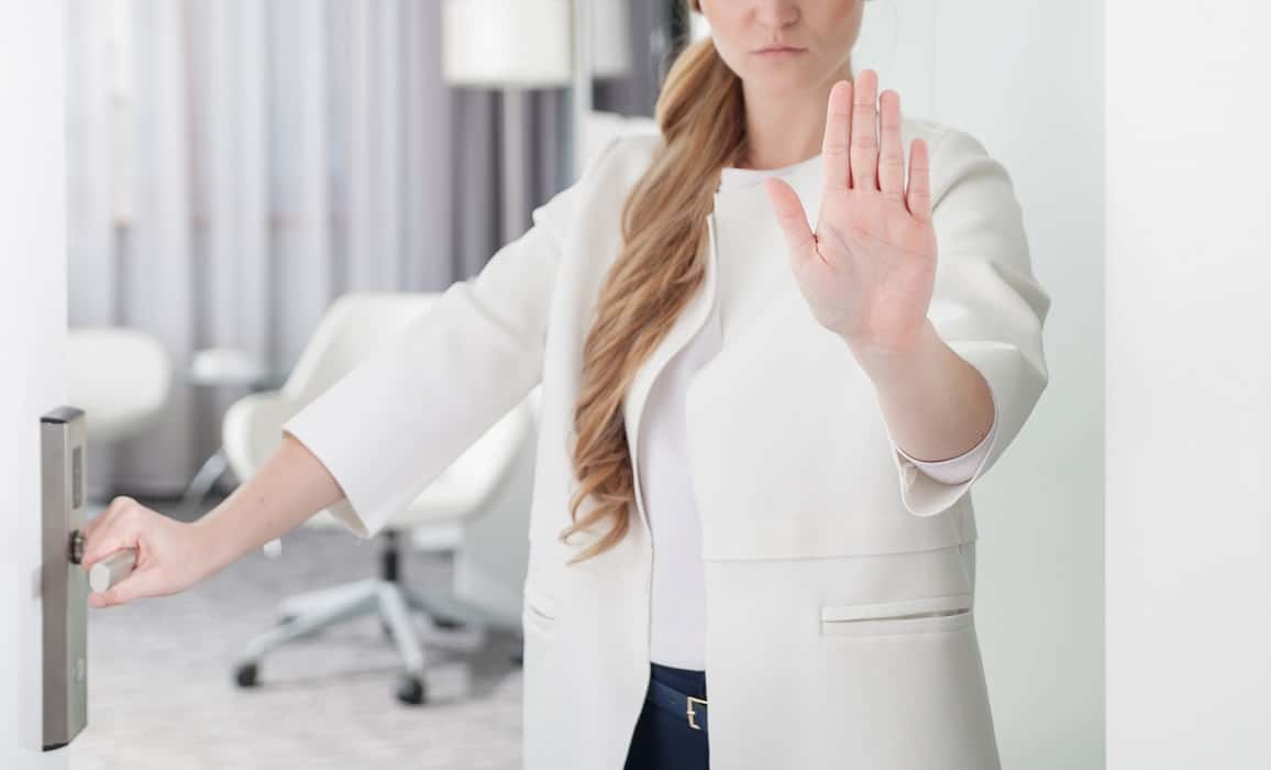 woman blocking entry with stop hand signal