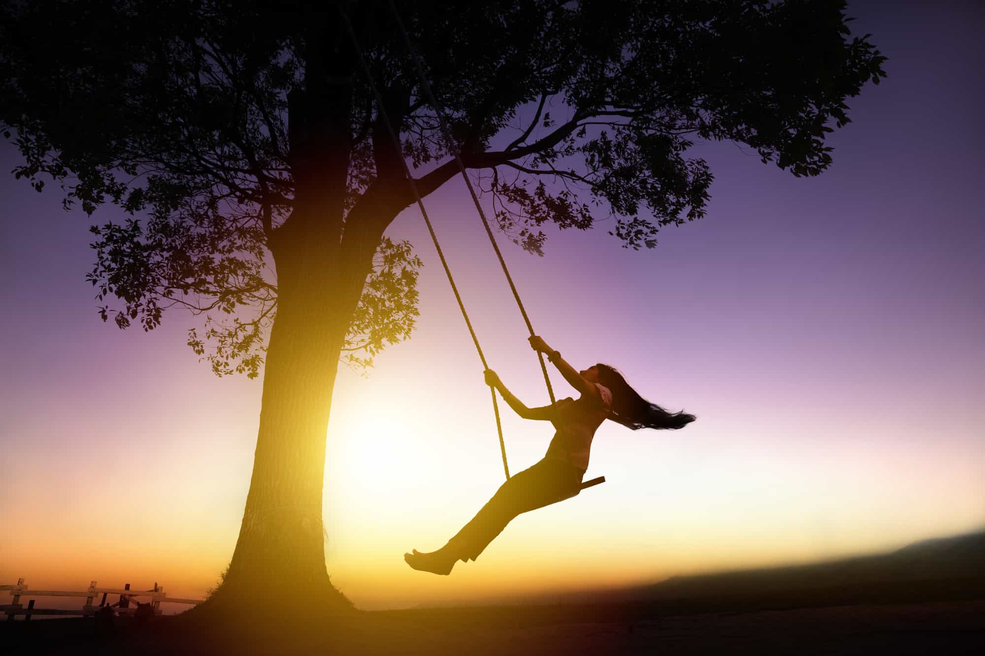 woman on swing in silhouette