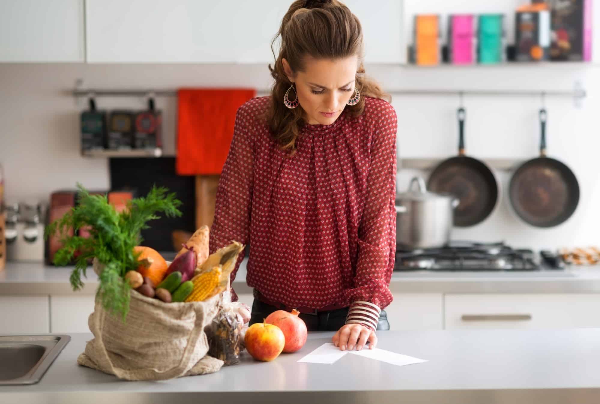 woman with groceries and receipt