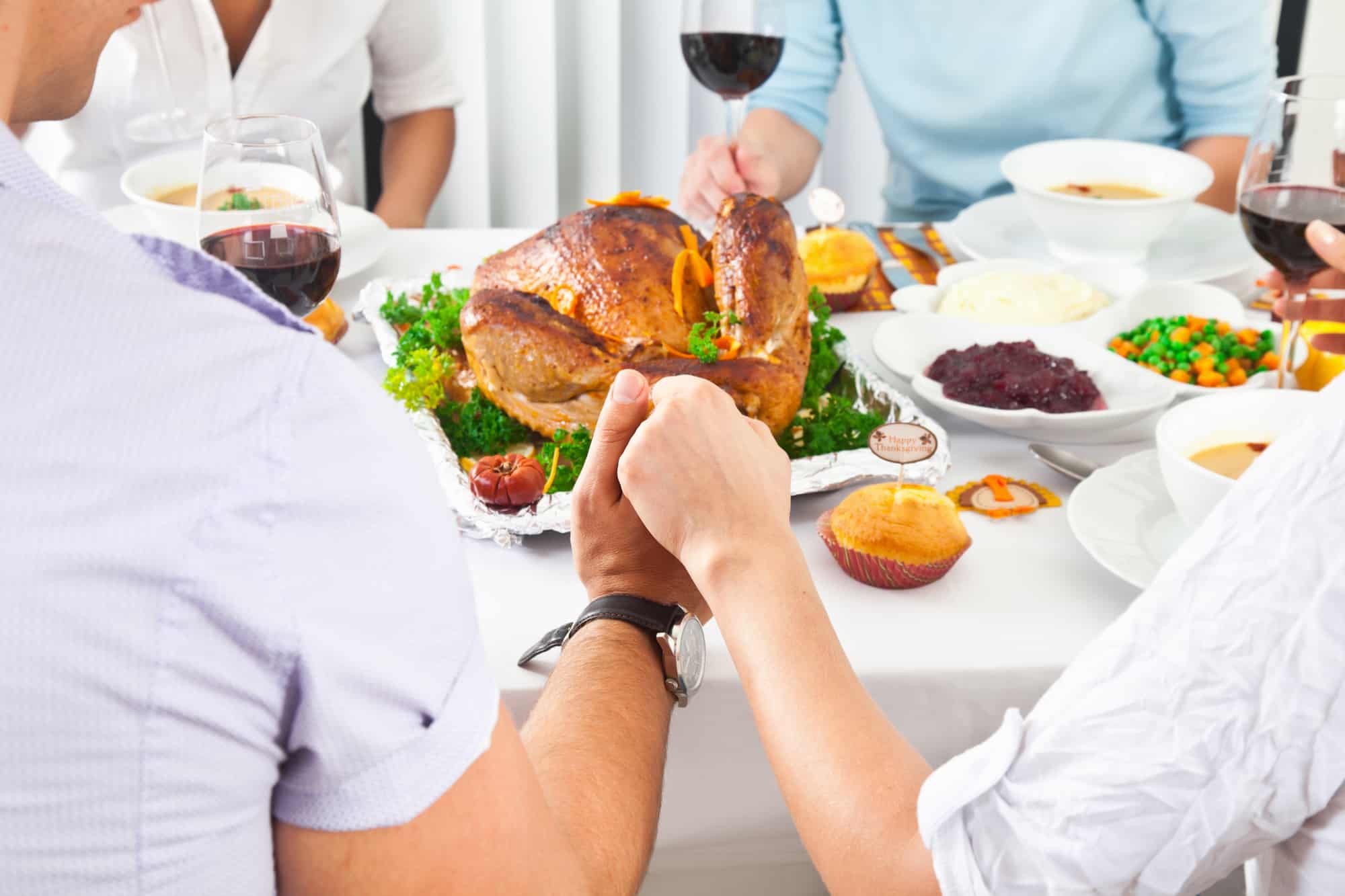 Thanksgiving family prayer around table