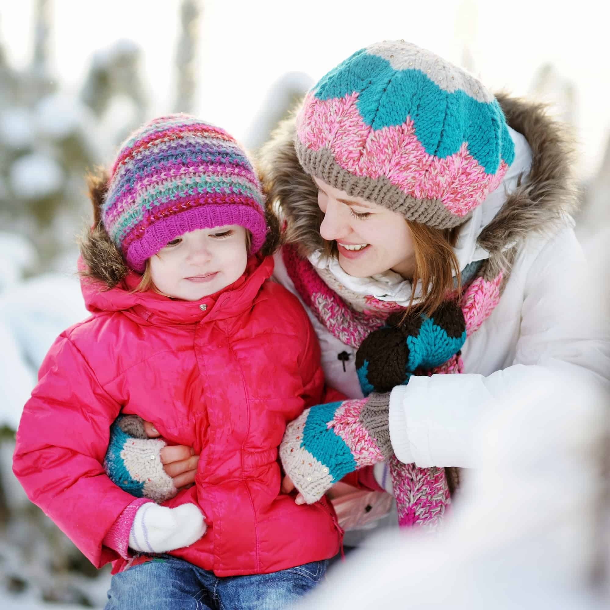 Young mother and her daughter at winter