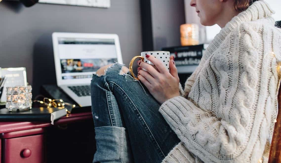 Woman drinking hot tea in her home office