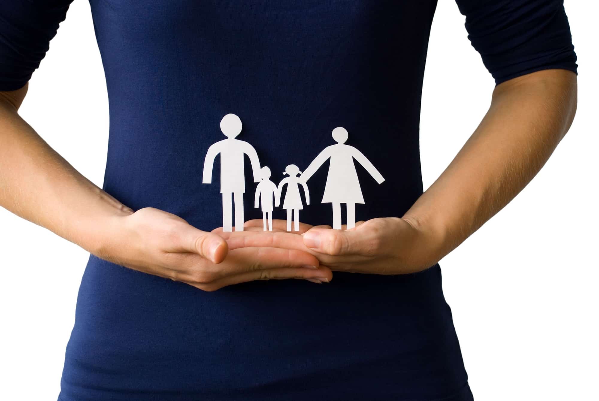 Woman's hands protecting a paper chain family