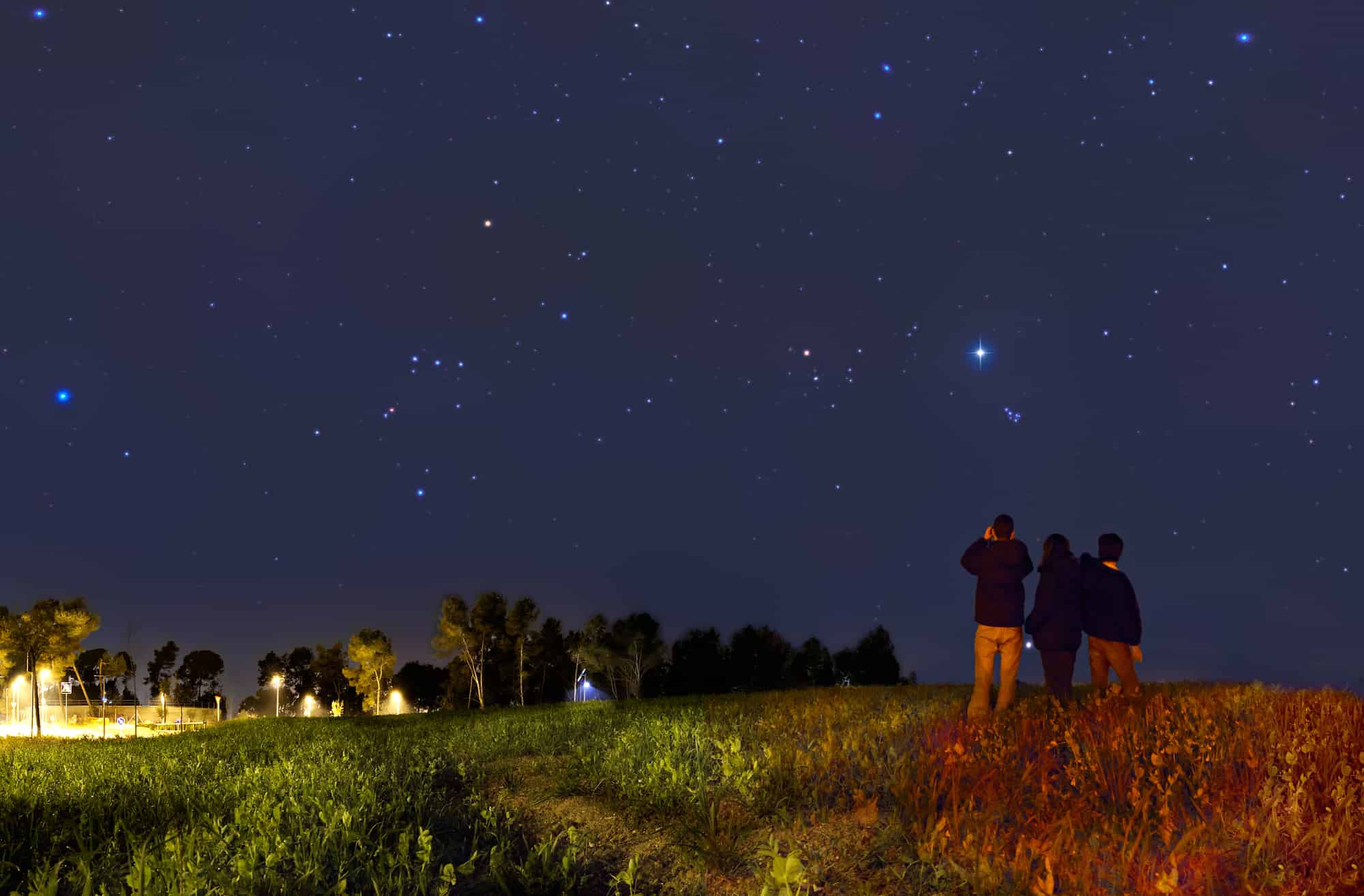 family looking at stars with binoculars