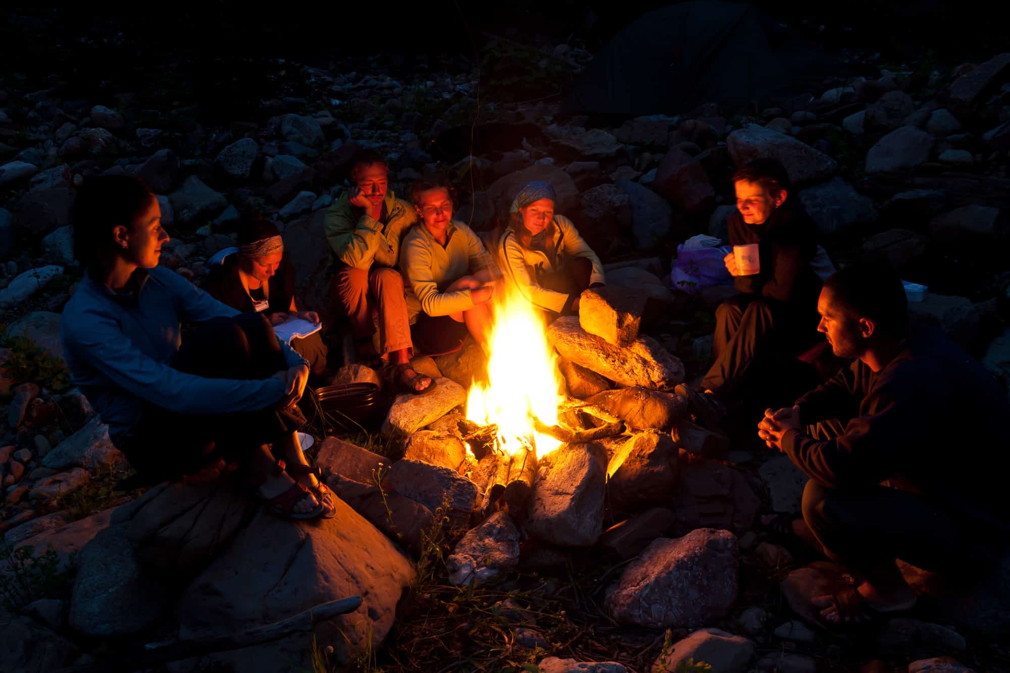 Family sitting around bonfire