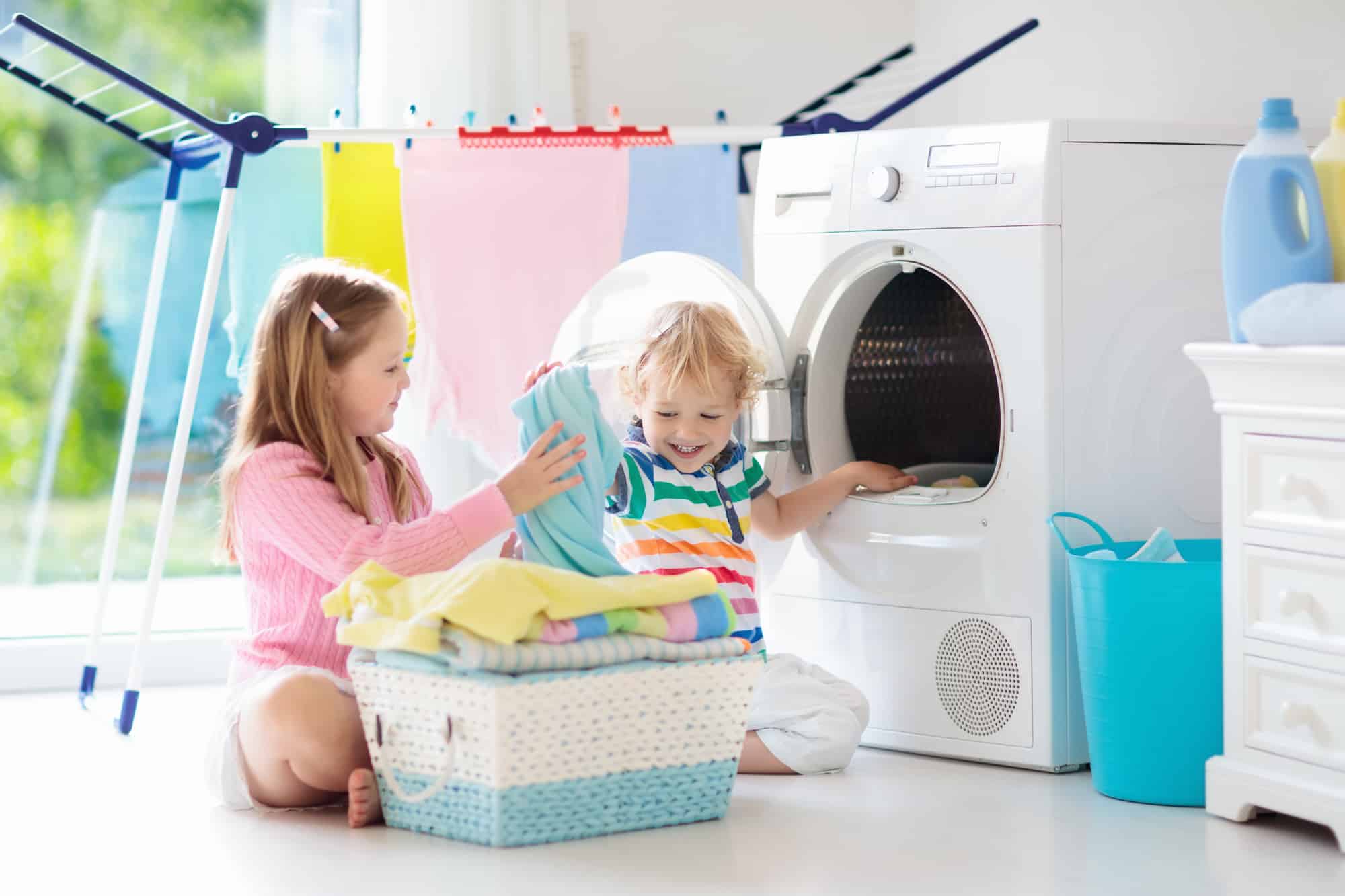Kids in laundry room with washing machine