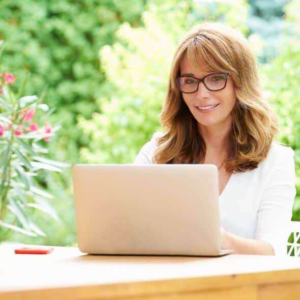 Woman using laptop in garden