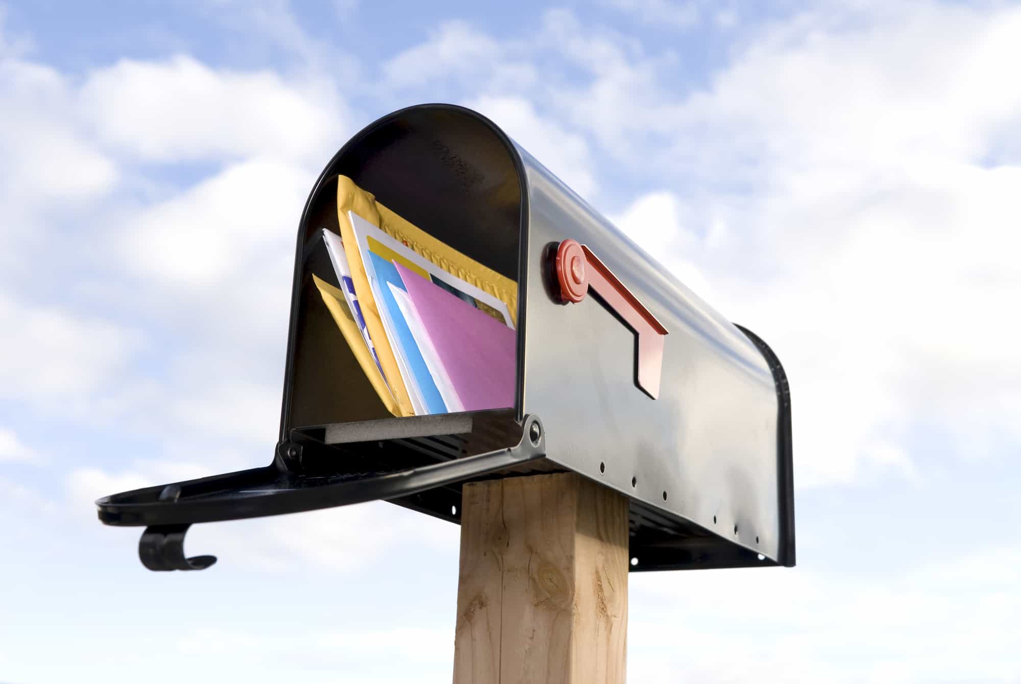 mail and envelopes in mailbox against sky