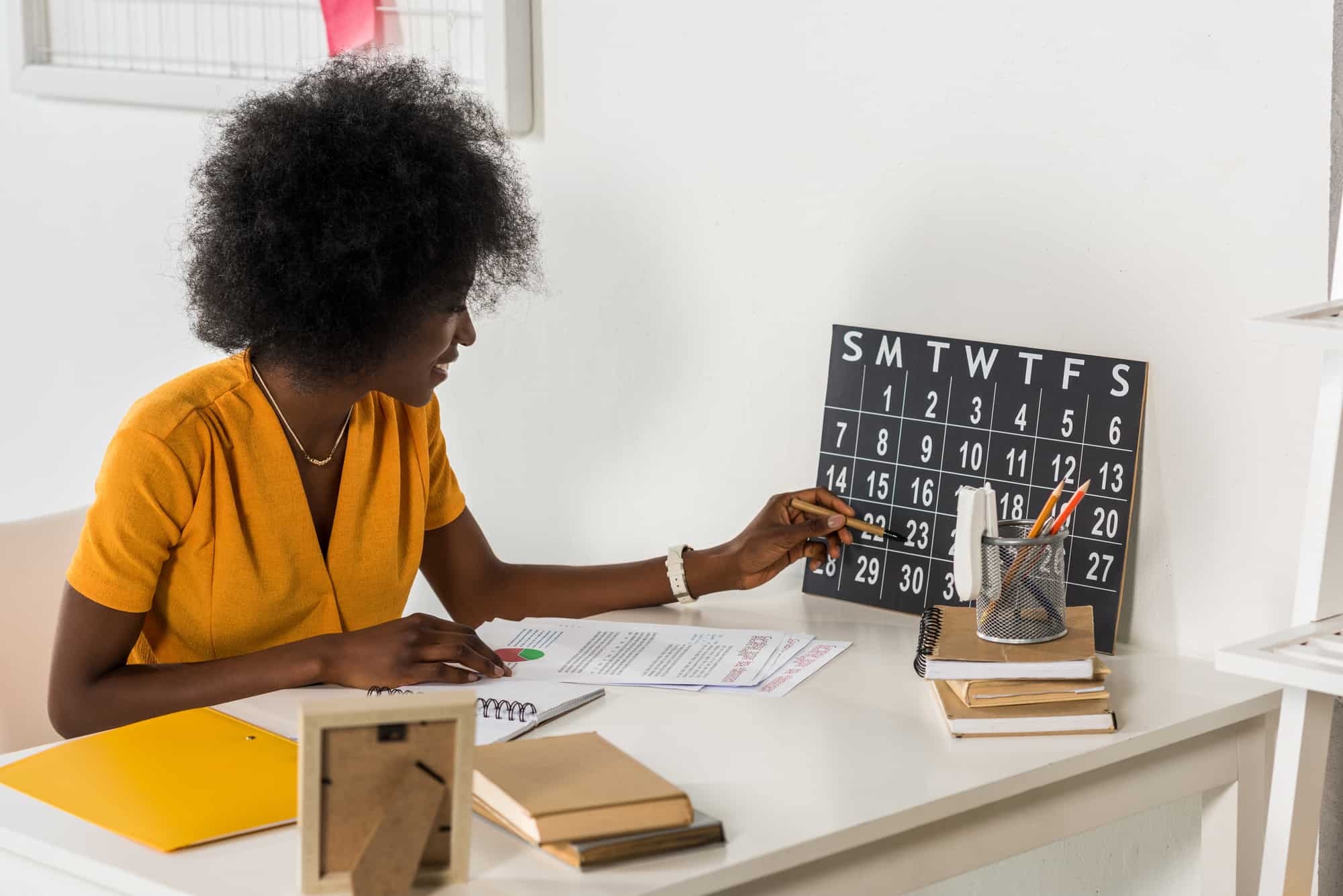 Woman checking calendar at workplace at home office