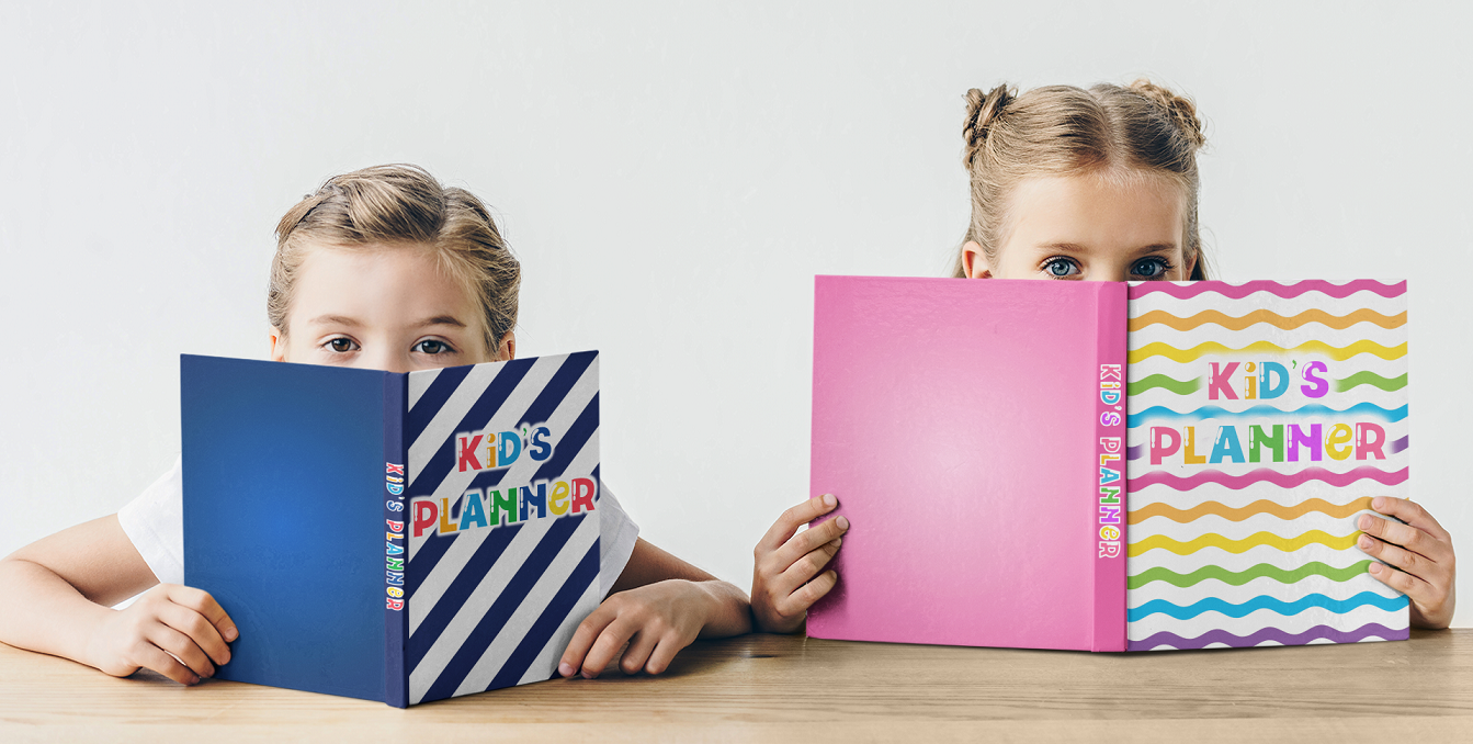 Two girls holding Kid's Planners